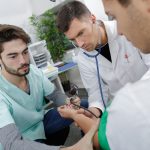 Student nurse taking patient’s bloodpressure