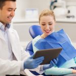 male dentist with tablet pc and woman patient
